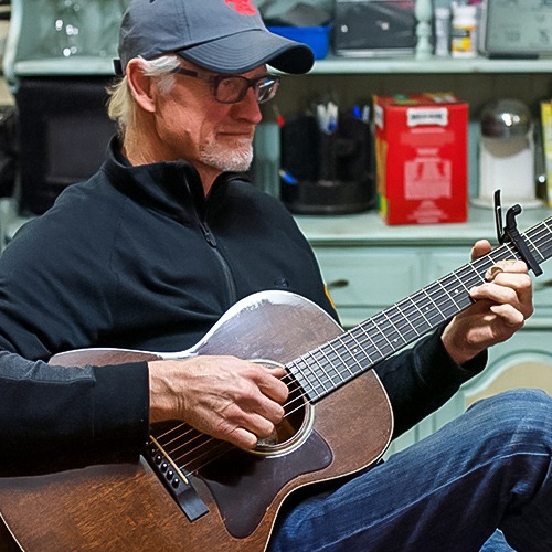 Man strumming a guitar
