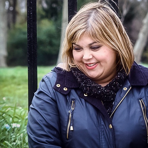 Woman smiling while looking down bashfully